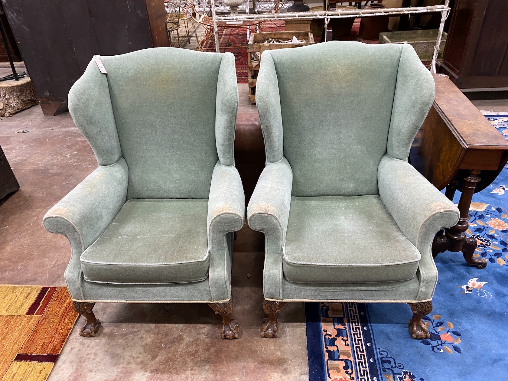 A pair of George III style wing armchairs, width 78cm, depth 66cm, height 99cm